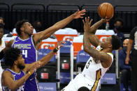 New Orleans Pelicans guard Eric Bledsoe, right, shoots against Sacramento Kings' Marvin Bagley III, left, and Buddy Hield, center, during the first quarter of an NBA basketball game in Sacramento, Calif., Sunday, Jan. 17, 2021. (AP Photo/Rich Pedroncelli)