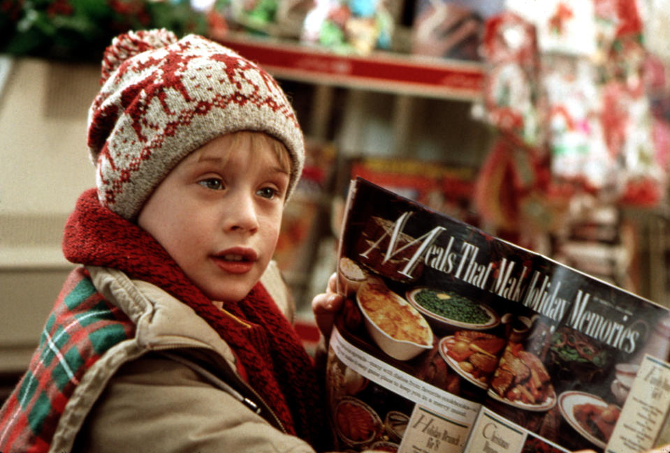 Macaulay Culkin looks at a magazine at a supermarket