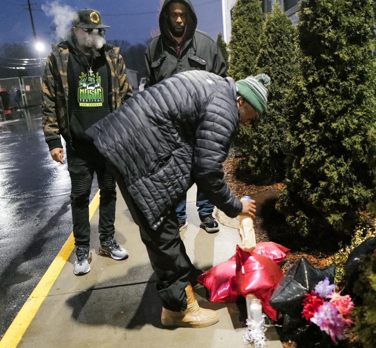 Mourners for Curshawn Terrell, pour alcholic beverages over the start of a remembrance memorial outside of his recording studio 51 Sessions on Tuesday, Jan. 3, 2023. Terrell, also known as Kaz Drumatic, was shot and killed on Dec. 31, 2022.