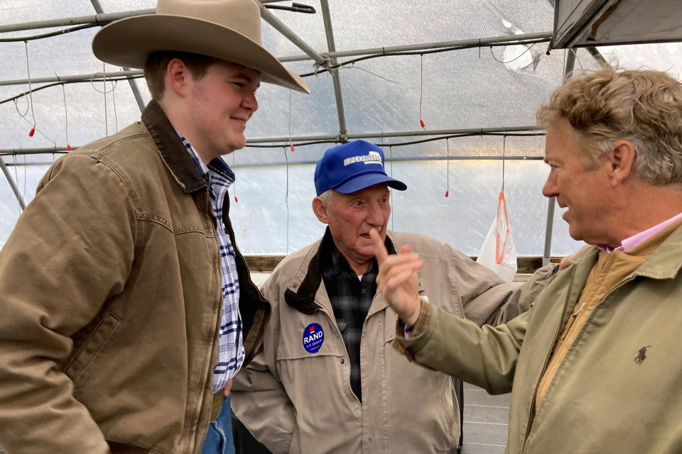 U.S. Sen. Rand Paul, R-Ky., right, chats with supporters at a fish fry on Tuesday, Oct. 18, 2022, in Garrard County, near Lancaster, Ky. Paul is seeking a third term in next month's midterm election. (AP Photo/Bruce Schreiner)