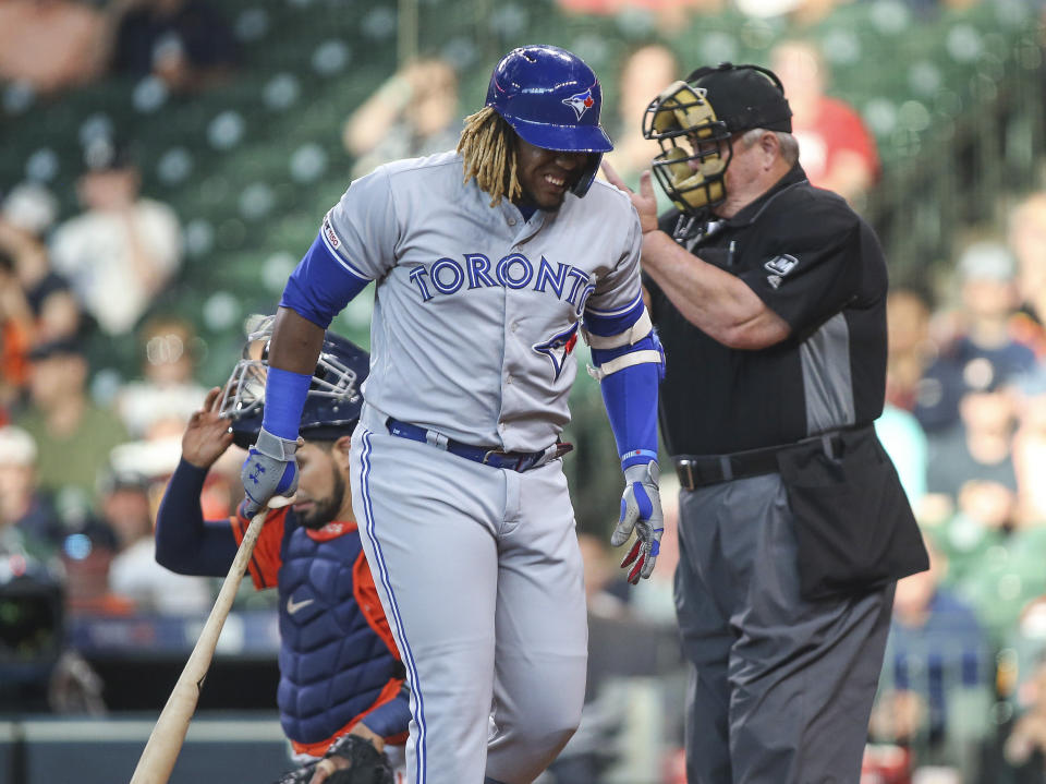 Jun 14, 2019; Houston, TX, USA; Toronto Blue Jays third baseman Vladimir Guerrero Jr. (27) reacts after being hit by a pitch against the Houston Astros during the first inning at Minute Maid Park. Mandatory Credit: Troy Taormina-USA TODAY Sports