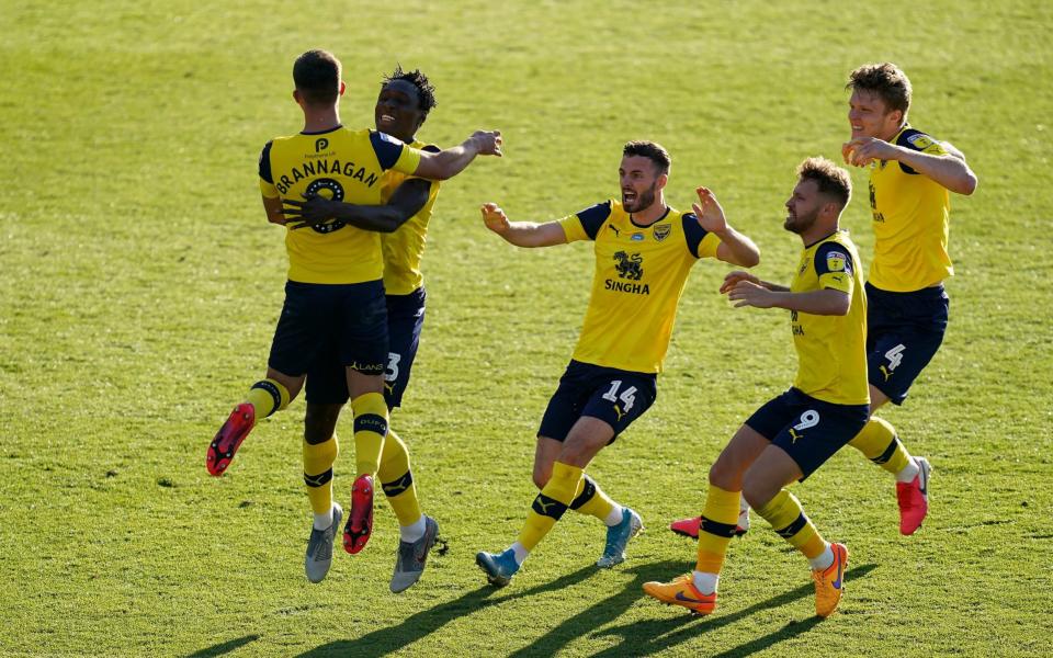 Oxford United's Cameron Brannagan (left) celebrates with his team-mates after scoring the winning penalty during the penalty shoot-out during the Sky Bet League One play-off semi-final, second leg match at the Kassam Stadium - John Walton/PA