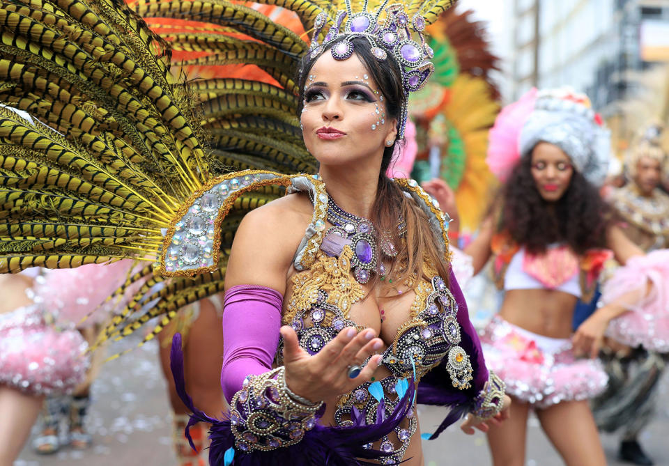 <p>A reveler takes part in the Monday parade, during the second and final day of the Notting Hill Carnival, in London, Monday Aug. 29, 2016. (Jonathan Brady/PA via AP) </p>