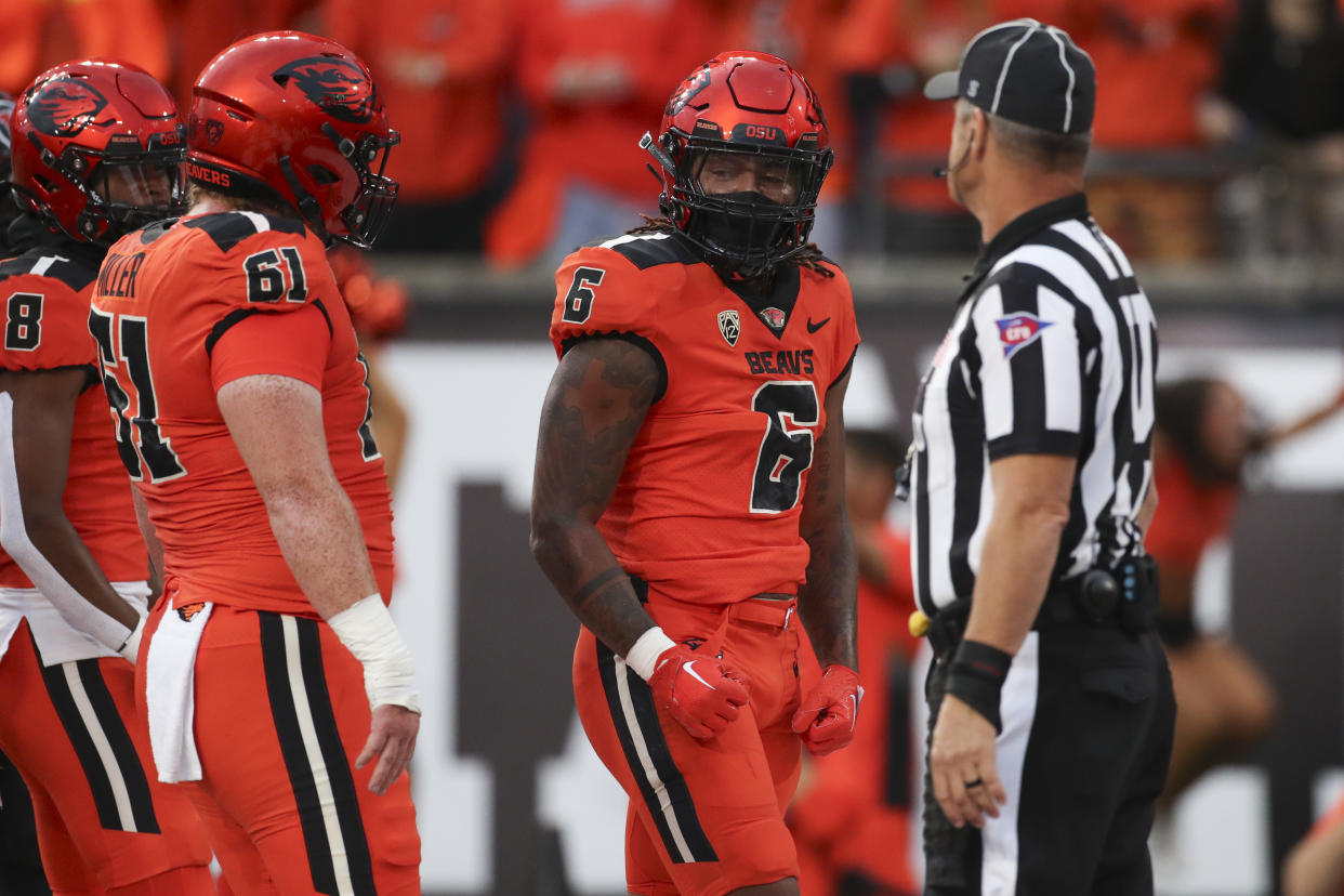 Oregon State running back Damien Martinez (6) celebrates with teammate Tanner Miller (61) after scoring a touchdown against Utah during the first half of an NCAA college football game Friday, Sept. 29, 2023, in Corvallis, Ore. (AP Photo/Amanda Loman)