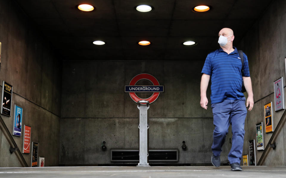 A man with a face mask exits the nearly empty Westminster tube station in London, Monday, April 27, 2020. While Britain is still in lockdown, some Nations have begun gradually easing coronavirus lockdowns, each pursuing its own approach but all with a common goal in mind, restarting their economies without triggering a new wave of infections.(AP Photo/Frank Augstein)