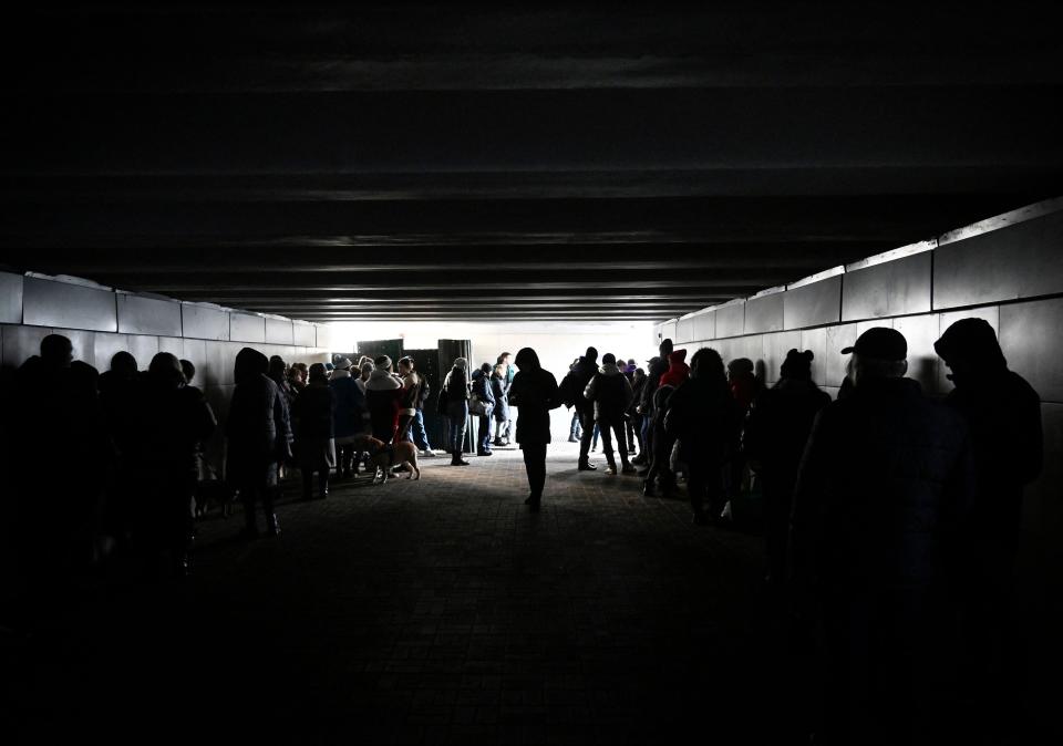 People shelter inside an underground pedestrian crossing during Russian missile strikes in Kyiv on Dec. 31, 2022.