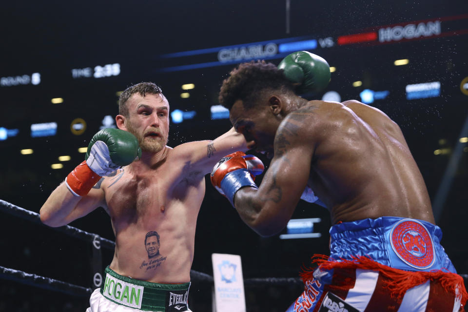 Ireland's Dennis Hogan punches Jermall Charlo during the fifth round of a WBC middleweight title boxing match Saturday, Dec. 7, 2019, in New York. (AP Photo/Michael Owens)