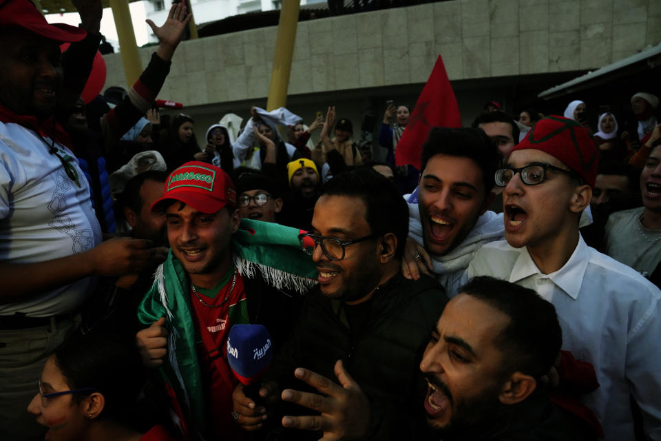 Moroccans celebrate in Rabat, Morocco, Saturday Dec. 10, 2022 their teams victory over Portugal in the World Cup quarter final soccer match played in Qatar. (AP Photo/Mosa'ab Elshamy)