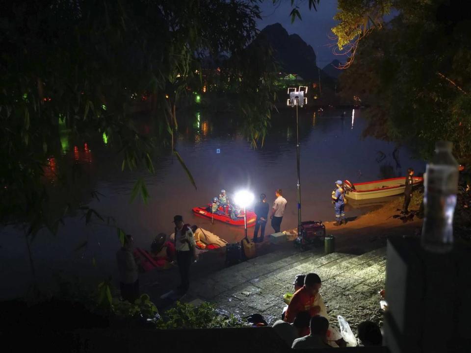 Rescuers search for missing boaters into the night after two dragon boats capsized in southern China, killing seventeen people (Chinatopix via AP)