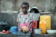 Elena Joaquin, 6, sits in a shelter in Buzi, Mozambique