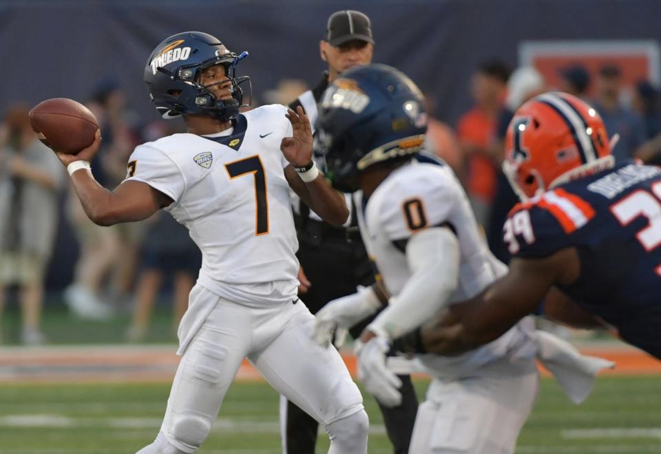 Sep 2, 2023; Champaign, Illinois, USA; Toledo Rockets quarterback Dequan Finn (7) passes during the first half against the Illinois Fighting Illini at Memorial Stadium. Mandatory Credit: Ron Johnson-USA TODAY Sports