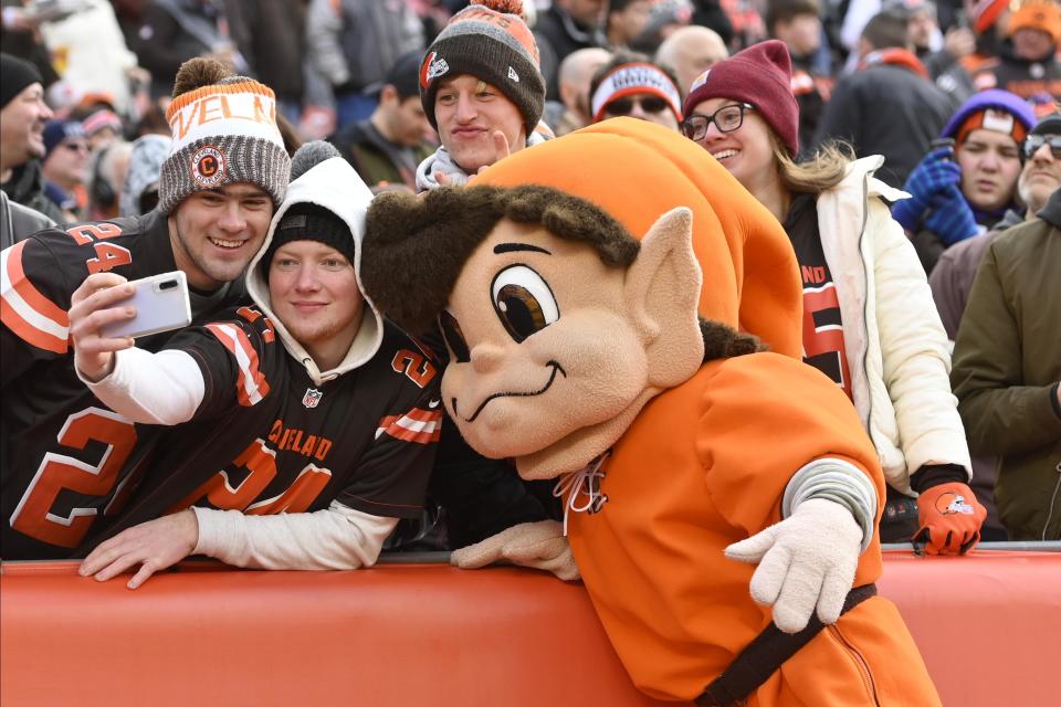 Cleveland Browns mascot Brownie the Elf poses for a picture with fans during an NFL football game between the Cincinnati Bengals and the Cleveland Browns, Sunday, Dec. 8, 2019, in Cleveland. The Browns won 27-19.