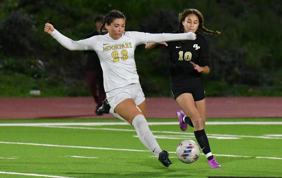 Moorpark's Amanda Parada (left) moves the ball ahead while being defended by Oak Park's Malea Johnson during a Coastal Canyon League match at Oak Park High on Monday, Jan. 29, 2024. Moorpark won 6-1 to clinch at least a share of the league title.