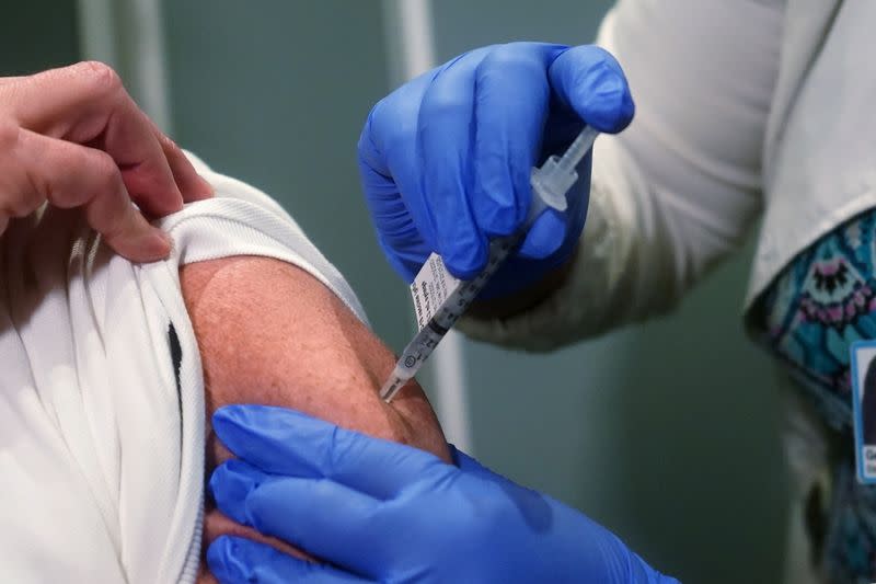 Nurse Mark Carey receives one of the first vaccinations at Mt. Sinai Hospital from Pfizer-BioNTech, in New York