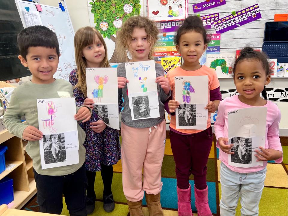 Students at Children’s Corner Preschool in Piscataway hold their drawings of dogs awaiting adoption at Edison Animal Shelter.