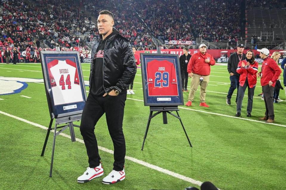 Former Fresno State baseball player Aaron Judge walks past his and coach Mike Batesole’s jerseys during a jersey retirement celebration at halftime of the Bulldog football team’s game against New Mexico at Bulldog Stadium on Saturday, Nov. 18, 2023.