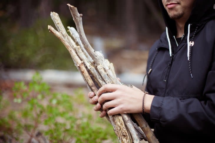 Man gathering sticks for campfire