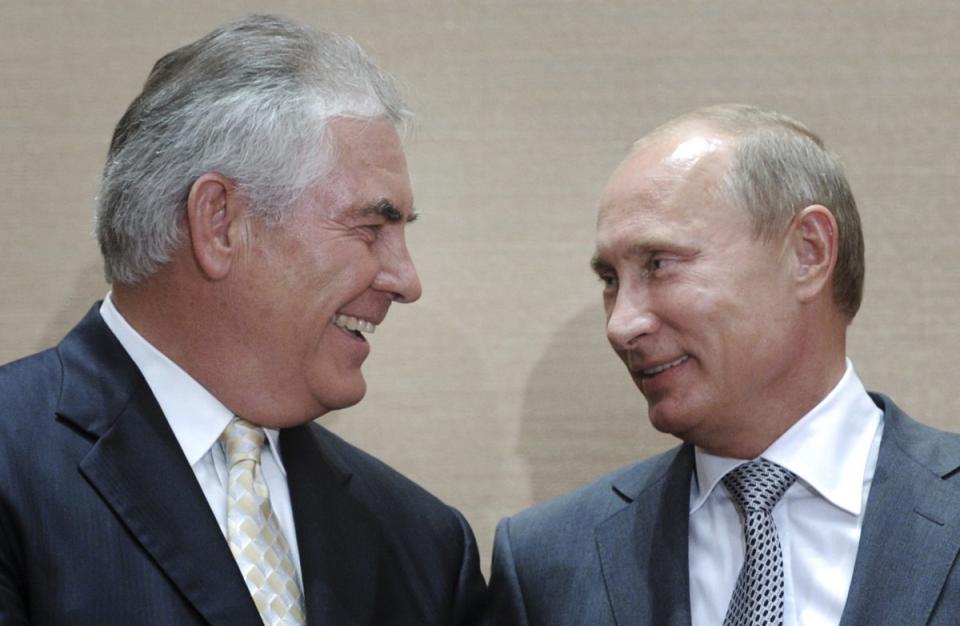 Then-Russian Prime Minister Vladimir Putin and Rex Tillerson, ExxonMobil's chief executive, smile during a signing ceremony in the Black Sea resort of Sochi, Russia on Aug. 30, 2011.