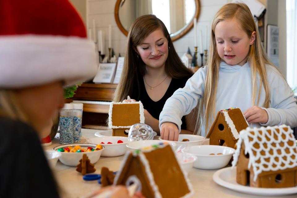 Kylie Priday, 15, left, smiles at her younger sister Zoe, 8, while they build gingerbread houses at their home in Saratoga Springs on Sunday, Dec. 3, 2023. | Megan Nielsen, Deseret News