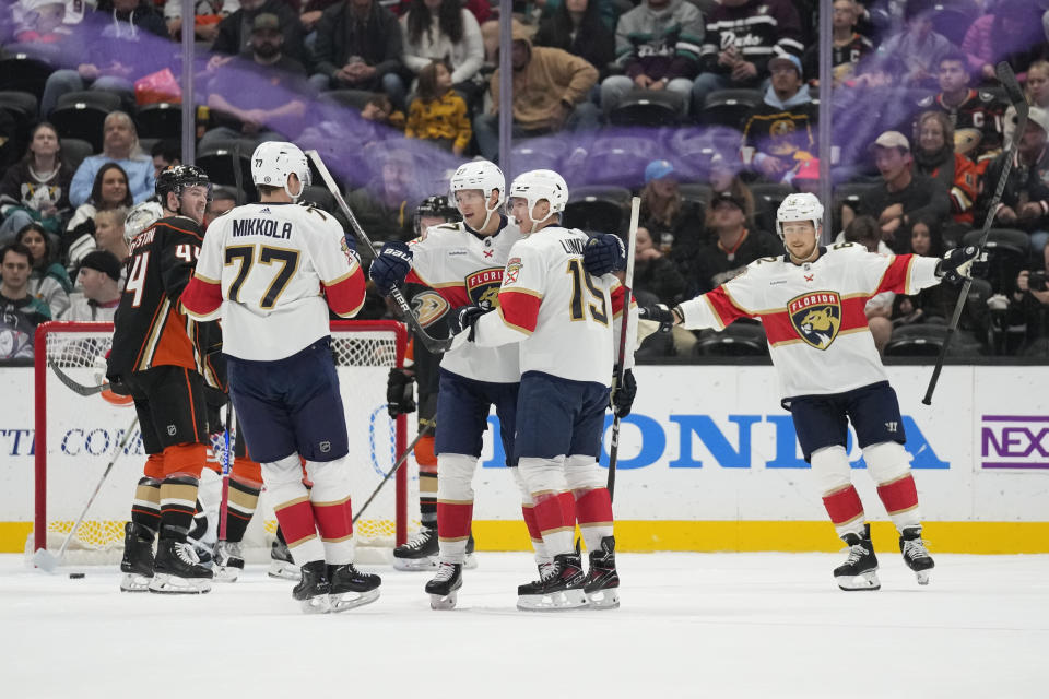 Florida Panthers center Eetu Luostarinen (27) celebrates with teammates after scoring during the first period of an NHL hockey game against the Anaheim Ducks in Anaheim, Calif., Friday, Nov. 17, 2023. (AP Photo/Ashley Landis)