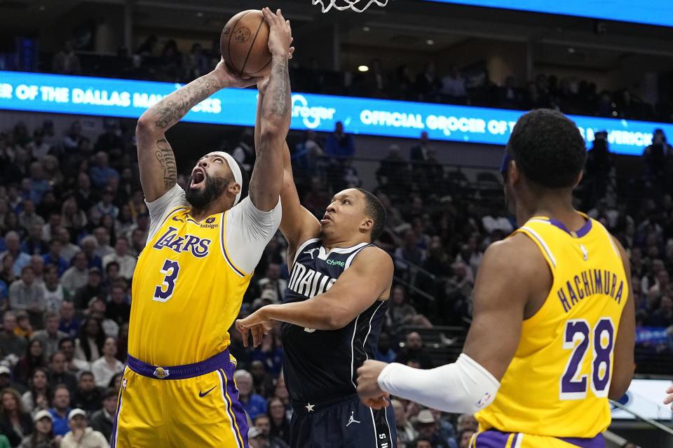 Los Angeles Lakers forward Anthony Davis (3) is fouled from behind by Dallas Mavericks forward Grant Williams during the second half of an NBA basketball game in Dallas, Tuesday, Dec. 12, 2023. (AP Photo/LM Otero)