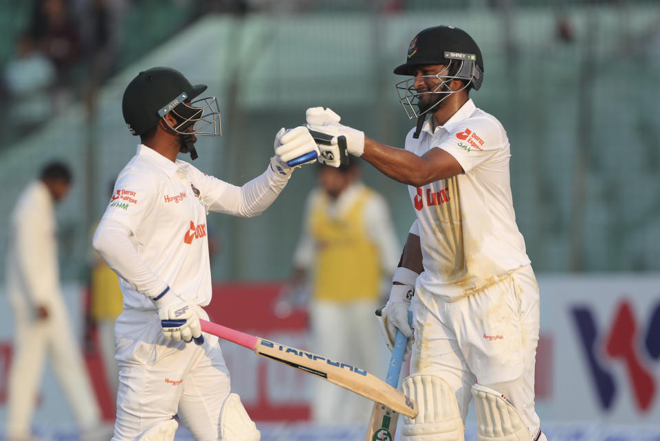 Bangladesh's Shakib Al Hasan, right, fist bumps with batting partner Mehidy Hasan Miraz during the day four of the first Test cricket match between Bangladesh and India in Chattogram, Bangladesh, Saturday, Dec. 17, 2022. (AP Photo/Surjeet Yadav)