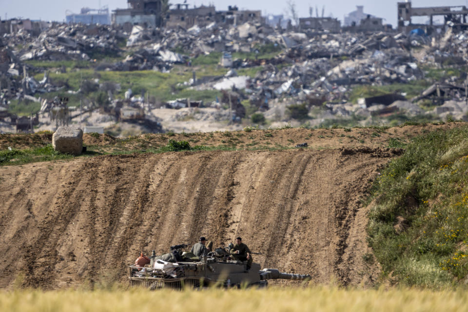 Israeli soldiers rest on top of their tank on the border with the Gaza Strip, in southern Israel, Tuesday, March 26, 2024. (AP Photo/Ariel Schalit)