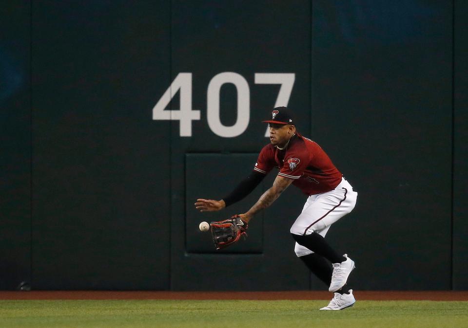 Diamondbacks centerfielder Ketel Marte makes a running catch on a ball hit by the Brewers' Lorenzo Cain leading off the game Sunday.