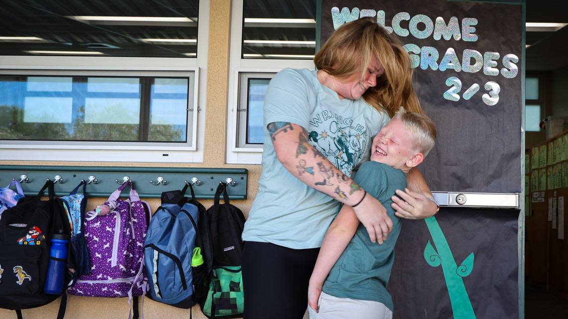 Rowen Hammer, 7, laughs after a big hug from mom Lauren Hammer as he starts second grade on Monday, Aug. 14, 2023, at Santa Margarita Elementary School. The campus welcomed 294 students as back-to-school festivities got underway in San Luis Obispo County.