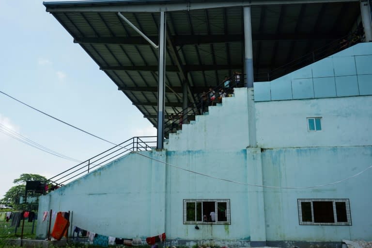 Hundreds of traumatised Hindus now sleep on grubby mats in the overcrowded concourse of a disused football stadium in Sittwe