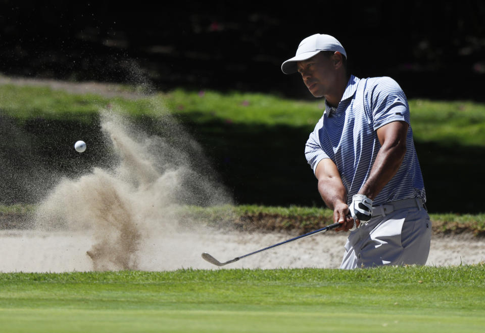 Tiger Woods hits from a sand trap on the first day of competition of the WGC-Mexico Championship at the Chapultepec Golf Club in Mexico City, Thursday, Feb. 21, 2019. (AP Photo/Marco Ugarte)