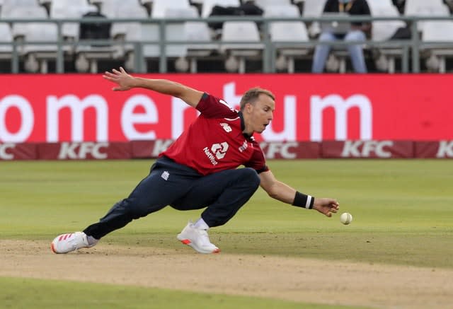 England bowler Tom Curran fields the ball off his own bowling