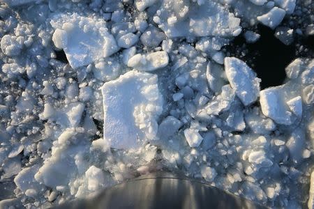 The bow of the Warren Jr., a 150 foot offshore supply boat, cuts a path through the ice as it works as an ice breaker for the commuter ferry in the waters off Hingham, Massachusetts March 3, 2015. REUTERS/Brian Snyder