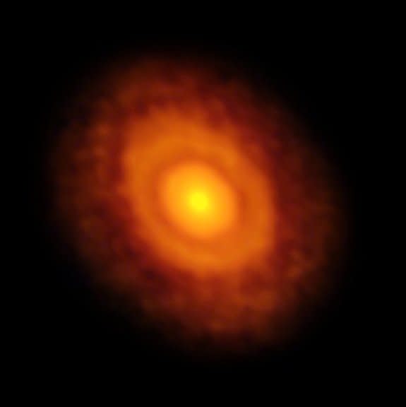 ALMA's radio image of the star V883 Orionis and its disk of gas, dust and debris — a precursor of planet formation. The water snow line is visible as a ring around the disk — the first dark ring after the