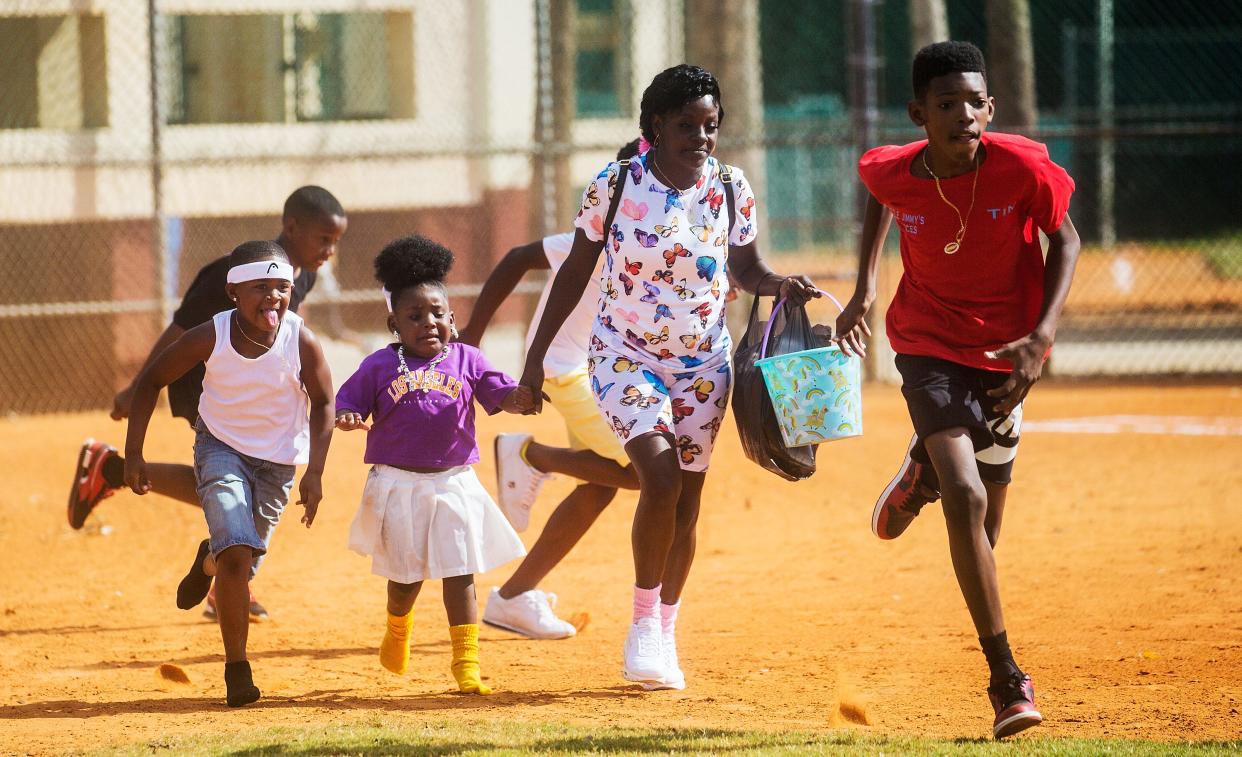 Children participate in an Easter Egg hunt  after the Dunbar Easter Parade at the Stars Complex on Sunday,  April, 4, 2021. 