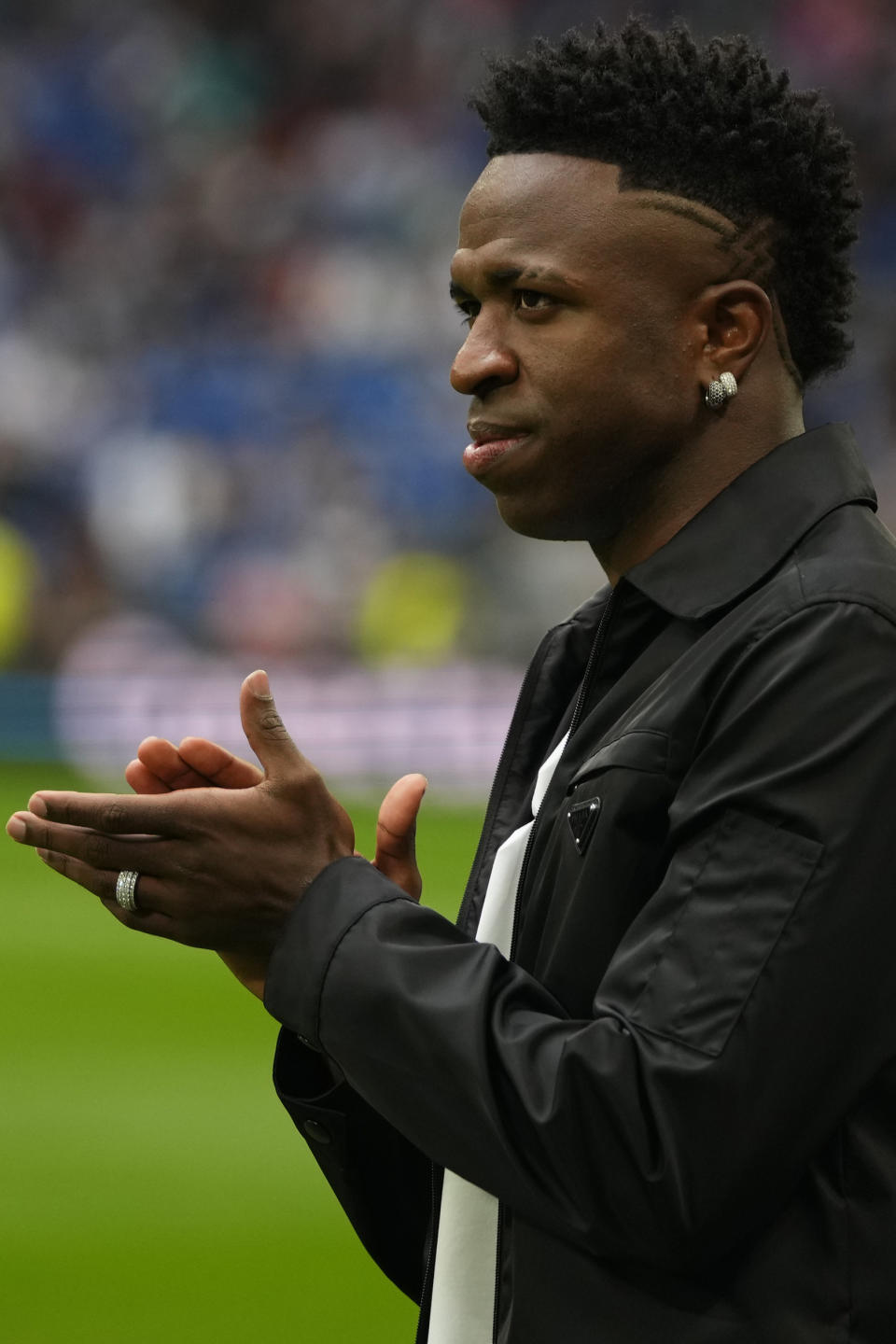 Real Madrid's Vinicius Junior applauds to spectators prior to a Spanish La Liga soccer match between Real Madrid and Rayo Vallecano at the Santiago Bernabeu stadium in Madrid, Spain, Wednesday, May 24, 2023. (AP Photo/Manu Fernandez)