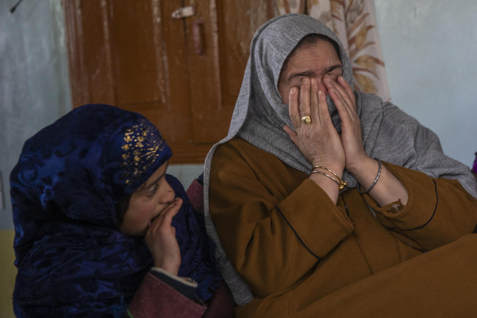 Dilshada Banoo, aunt of 16-year-old Athar Mushtaq, breaks down while talking to Associated Press in Bellow, south of Srinagar, Indian controlled Kashmir, Tuesday, Jan. 5, 2021. On the last week of 2020, Indian government forces killed Athar and two other young men during a controversial gunfight on the outskirts of the Indian-controlled Kashmir’s main city. Police did not call them anti-India militants but “hardcore associates of terrorists." They later buried them at a graveyard in a remote mountainous tourist resort miles away from their ancestral villages. Athar was the latest Kashmiri to be buried in a far-off graveyard after Indian authorities in a new controversial policy in 2020 started to consign blood-soaked bodies of scores of Kashmiri suspected rebels to unmarked graves, denying the mourning families a proper funeral and a burial. (AP Photo/ Dar Yasin)