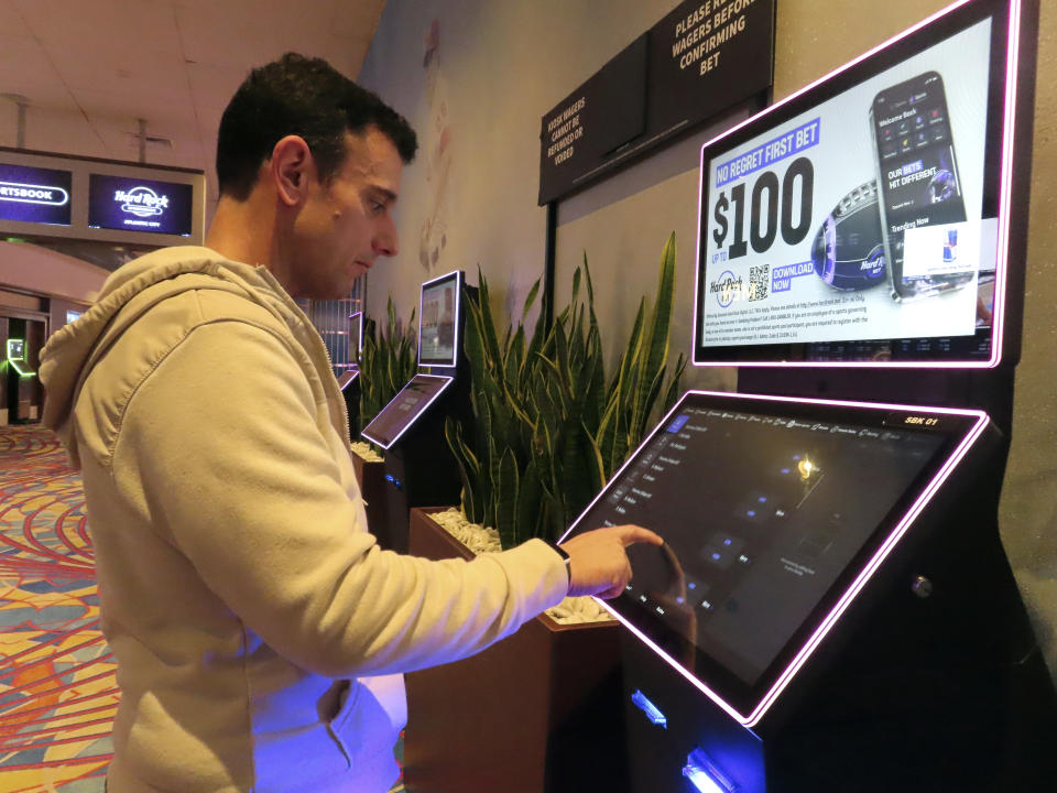 Matt Smircich, of Hamburg, N.J., makes sports bets at the Hard Rock casino in Atlantic City, N.J., Friday, Feb. 2, 2024. On Tuesday, Feb. 6, 2024, the American Gaming Association estimated that a record 68 million Americans would wager a total of $23.1 billion on this year's Super Bowl, legally or otherwise. (AP Photo/Wayne Parry)