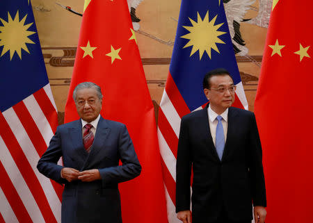 Malaysia's Prime Minister Mahathir Mohamad and China's Premier Li Keqiang arrive for a signing ceremony at the Great Hall of the People in Beijing, China, August, 20, 2018. How Hwee Young/Pool via REUTERS