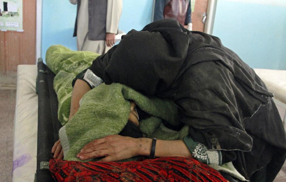 A mother hugs the dead body of her daughter following an attack, at a hospital in Ghazni city, Afghanistan, Monday, May 12, 2014. The attacks happened on the outskirts of the city in the province by the same name, said deputy provincial governor, Mohammad Ali Ahmadi. Two women and a policeman were killed, while two policemen and six civilians, including three children, were wounded, added Ahmadi. (AP Photo/Rahmatullah Nikzad)