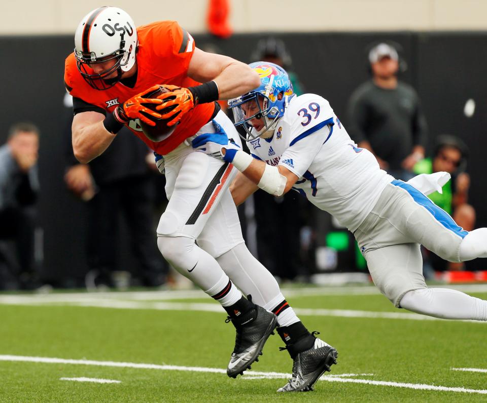 Oklahoma State's Blake Jarwin (47) picks up Kansas' Michael Glatczak (39) during a college football game between the Oklahoma State University Cowboys (OSU) and Kansas Jayhawks (KU) in Stillwater, Oklahoma, Saturday, October 24th.  , 2015. Photo by Nate Billings, The Oklahoman