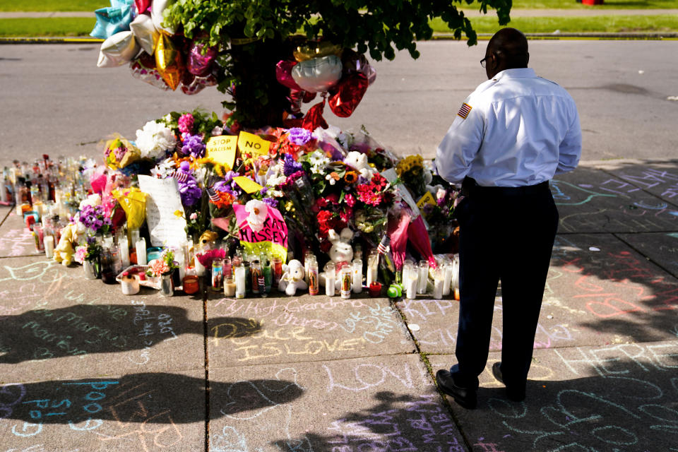 Howard Patton pays his respects at the scene of Saturday's shooting at a supermarket, in Buffalo, N.Y., Wednesday, May 18, 2022. (AP Photo/Matt Rourke)