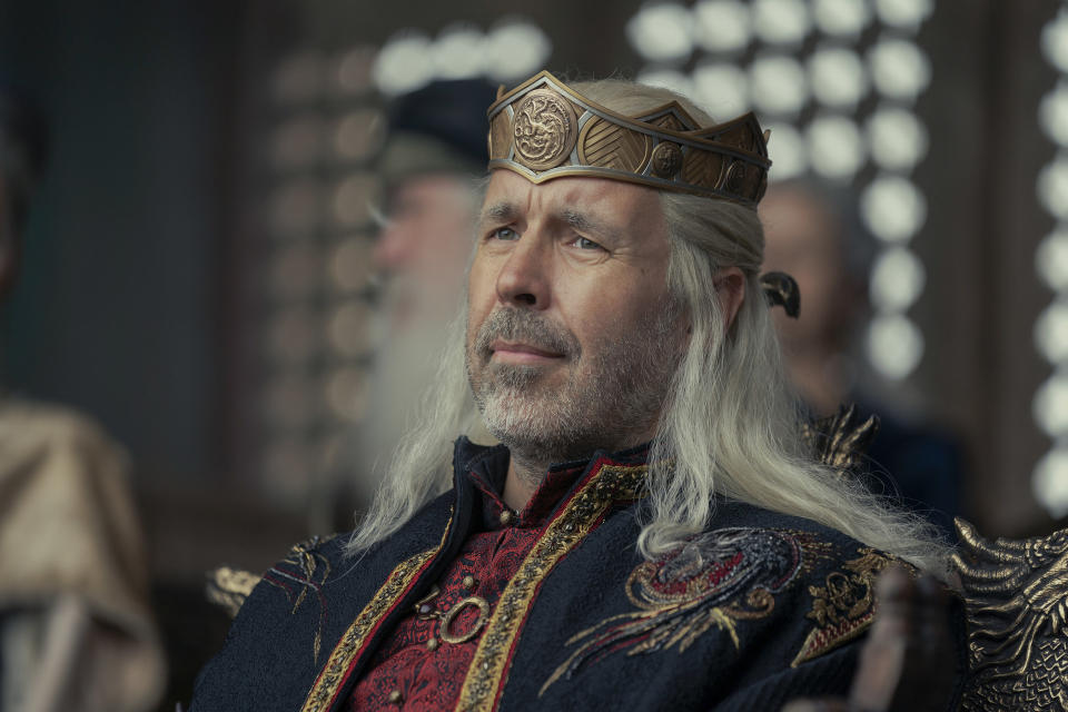 Viserys wears his crown and sits frowning