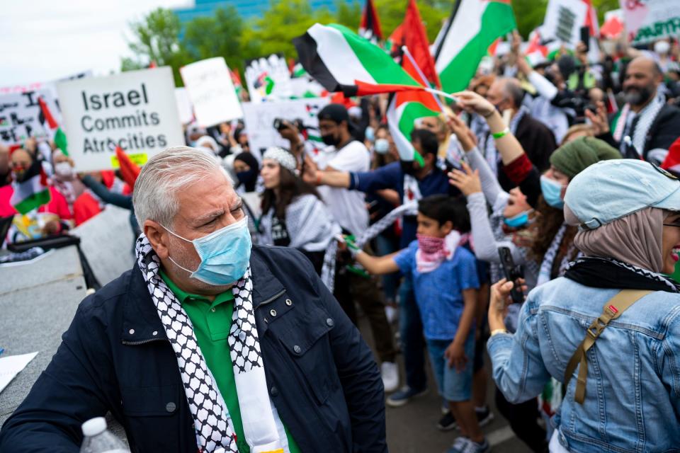 Osama Siblani, publisher of the Arab American News, takes in the scene as people chant during a rally and march in support of Palestine held by New Generation for Palestine on Sunday, May 16, 2021, in Dearborn.