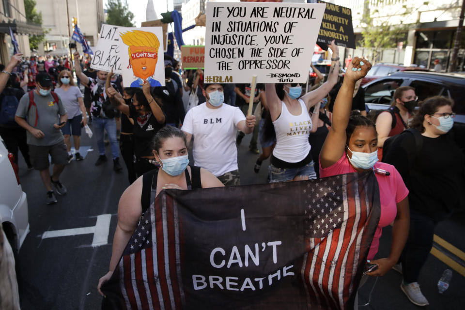 Demonstrators march near the BOK Center where President Trump will hold a campaign rally in Tulsa, Okla., Saturday, June 20, 2020. (AP Photo/Charlie Riedel)