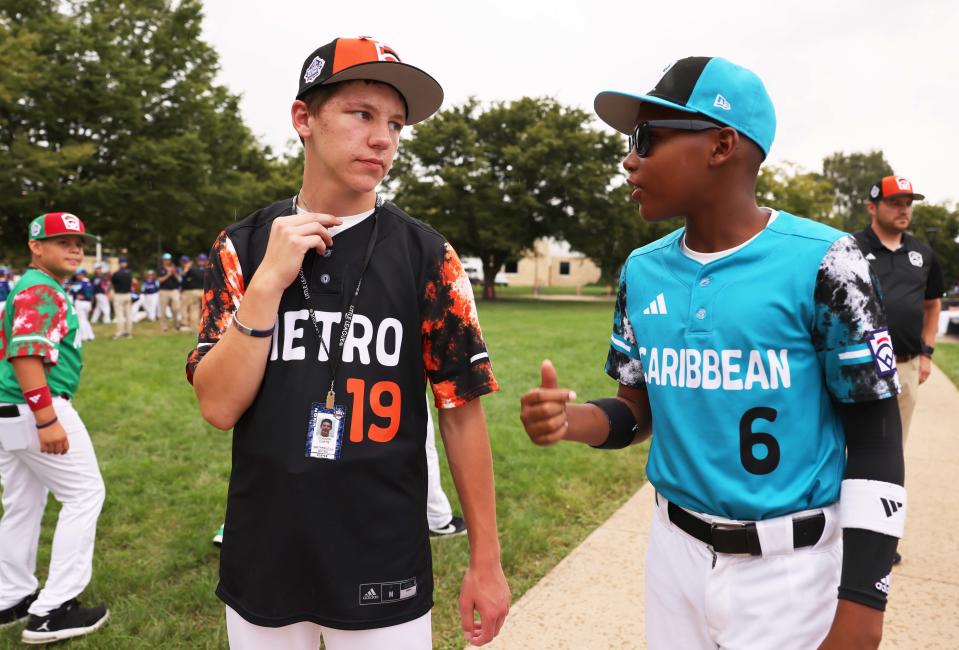Smithfield's Connor Curtis speaks with a Caribbean player at the World Series Picnic at Pennsylvania College of Technology on Monday in Williamsport, Pa.