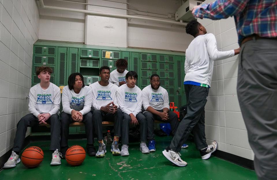 The Providence Cristo Rey varsity boys basketball team listens to head coach Scott Miller on Tuesday, Jan. 16, 2024, before a game against Arsenal Technical High School. The team has seven players.