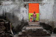 <p>Elena Zapata, 69, a housewife, poses for a portrait with her granddaughter Mariana, 3, inside the ruins of her house after an earthquake in Tepalcingo, Mexico, September 29, 2017. The house was badly damaged but with the help of her family and soldiers Zapata rescued some furniture. She lives in her backyard and hopes to return when the damage is repaired. “The most valuable that I have is the life of my granddaughter. We hope the authorities come to visit us. I feel anguish, I hear noises, I just want to cry,” Zapata said. (Photo: Edgard Garrido/Reuters) </p>