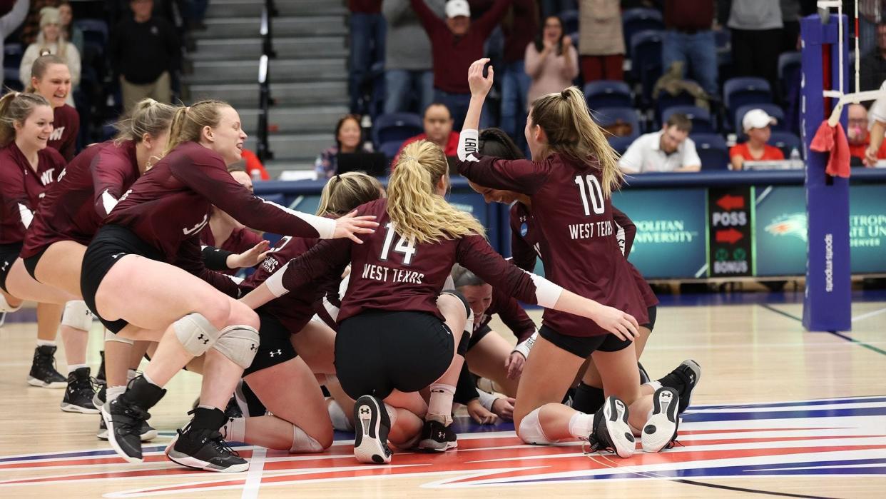The West Texas A&M volleyball team celebrates after winning its Final Four contest against Mo.-St. Louis.