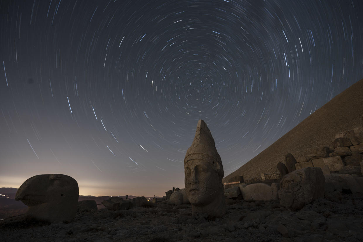 This time-lapse photo shows the Perseid meteor shower in the skies over the massive stone head sculptures at the archaeological site of Mount Nemrut in Adyaman, southeastern Turkey, on Aug. 11, 2024. / Credit: KEMAL ASLAN/AFP via Getty Images